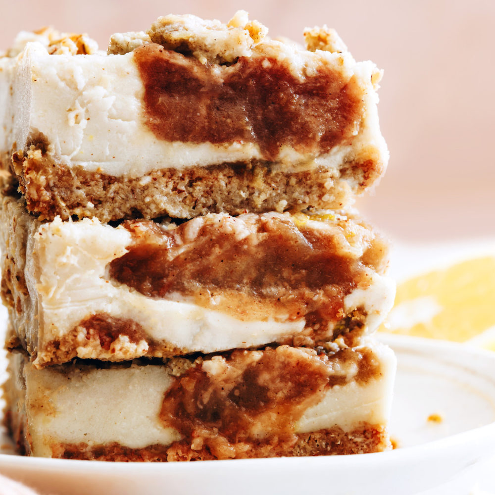 Plate stacked with three apple butter cheesecake bars
