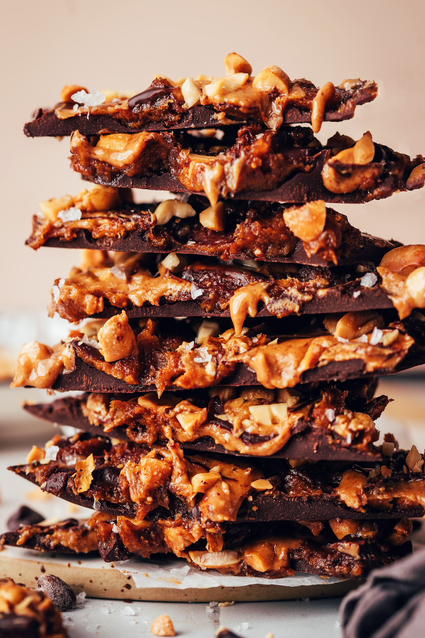 Stack of pieces of Snickers chocolate bark with date caramel and peanuts in it