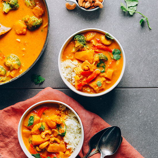 Bowls and skillet of our Amazing Vegan Yellow Pumpkin Curry recipe