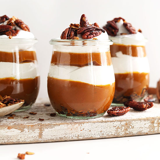 Three small jars of our Pumpkin Pie Parfaits recipe with orange and white layers