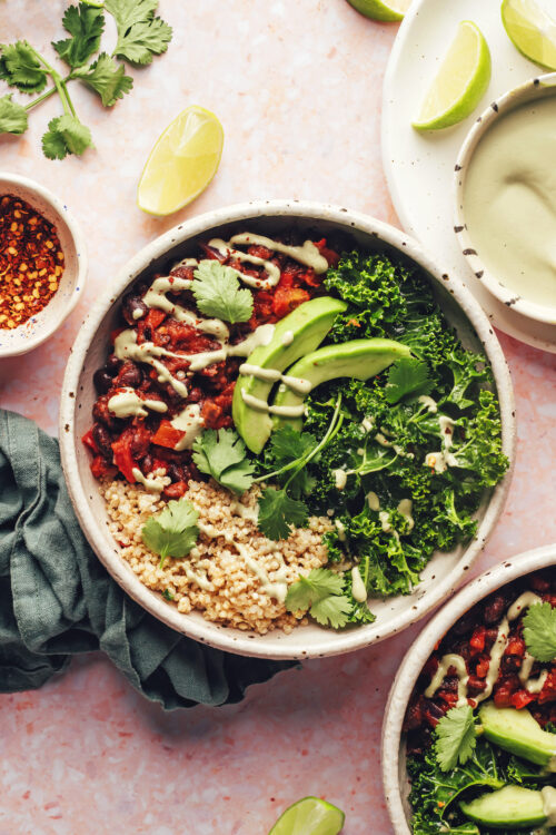 Vegan bowls with chili, quinoa, avocado, cashew jalapeno sauce, and massaged kale