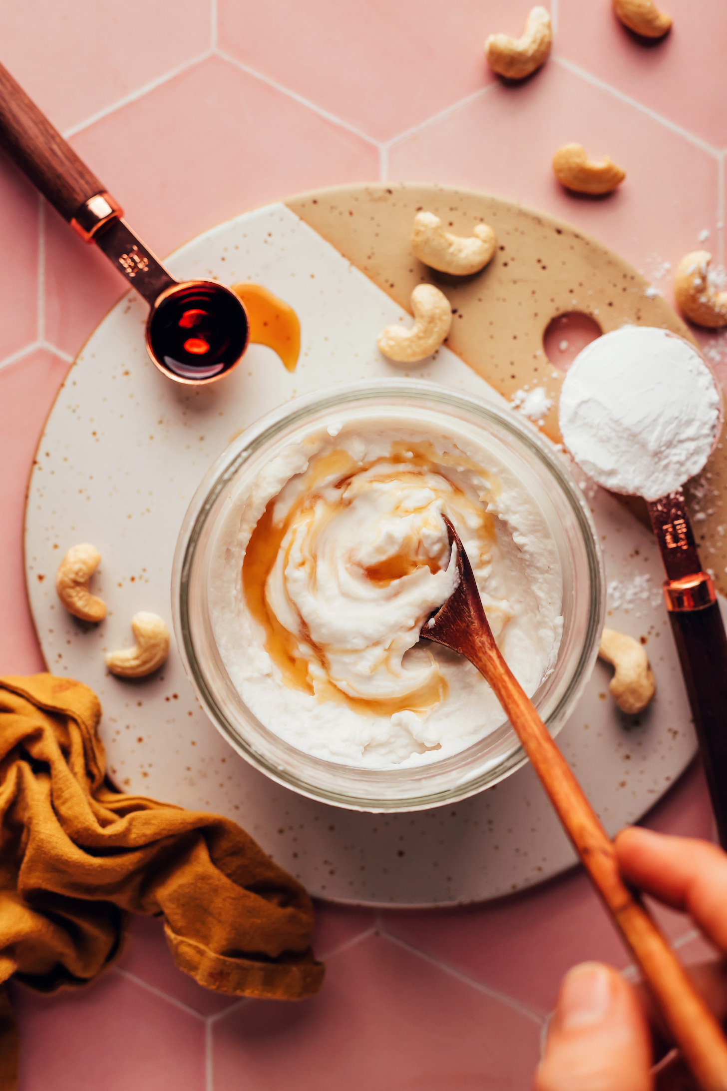 Stirring vanilla into vegan cashew whipped cream